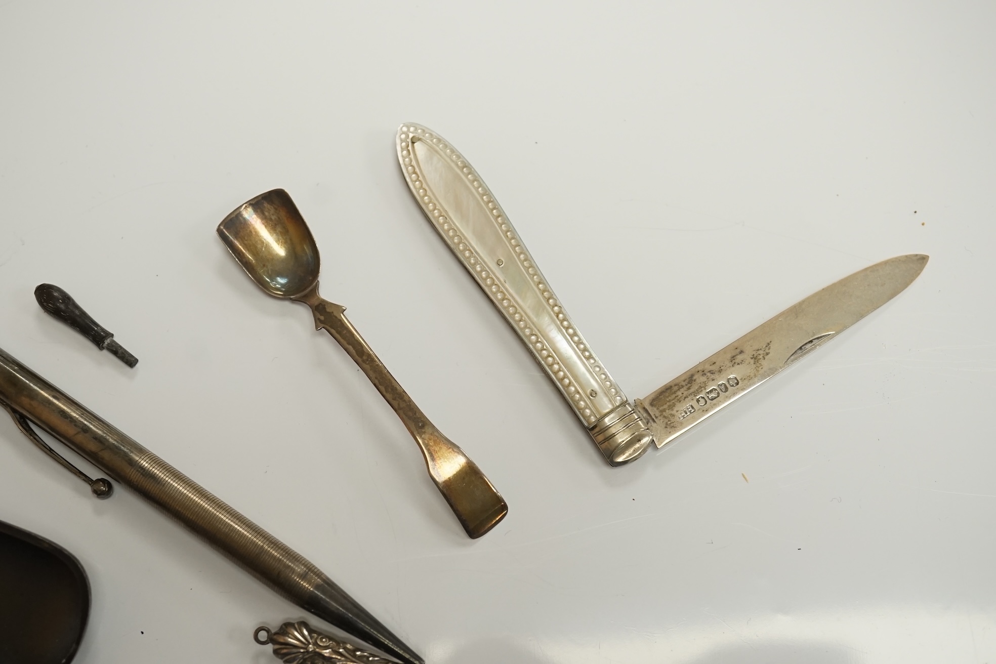 A small collection of mainly small silver items including a Victorian fruit knife, bookmarks, hare child's rattle, etc. Condition - fair